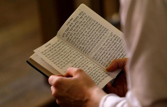 David Peter, chief Rabbi of Prague, reads from a religious script during a morning prayer inside the High Synagogue in Prague, Czech Republic. Photo by David W Cerny