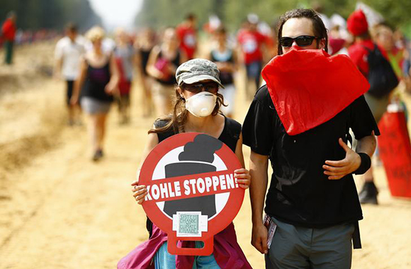 Protesters hold a banner reading "Stop Coal!"during "Ende Gelaende" demonstrations against the open cast Garzweiler brown coal mining near Bedburg, Germany August 26, 2017. Photo by Thilo Schmuelgen