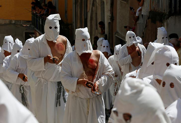 Penitents take part in a religious procession in Guardia Sanframondi, south Italy, August 27, 2017. Photo by Ciro De Luca