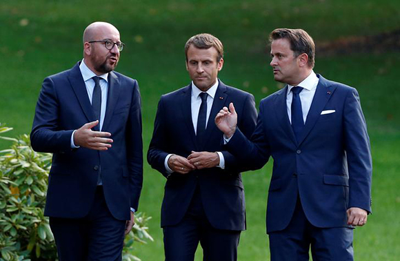French President Emmanuel Macron listens to Belgian Prime Minister Charles Michel and Luxembourg's Prime Minister Xavier Bettel at Senningen castle in Luxembourg, August 29, 2017. Photo by Francois Lenoir