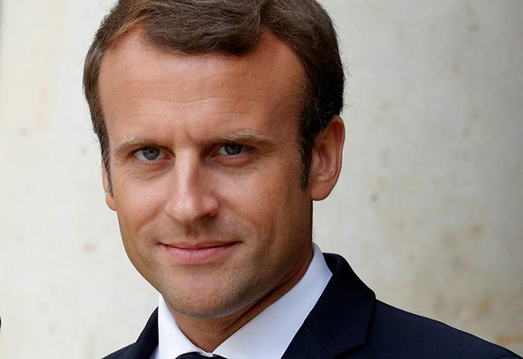 French President Emmanuel Macron waits for guests at the Elysee Palace in Paris, France. Photo by Philippe Wojazer
