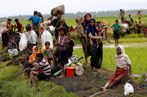 Rohingya refugees rest after travelling over the Bangladesh-Myanmar border in Teknaf, Bangladesh Photo by Mohammad Ponir Hossain