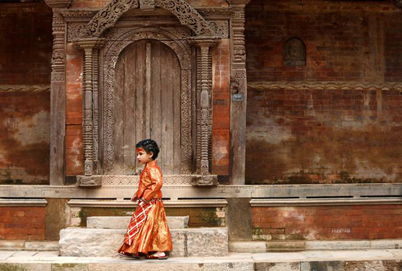 A young girl dressed as the Living Goddess Kumari participate the Kumari Puja festival. Kathmandu, Nepal Photo by Navesh Chitrakar
