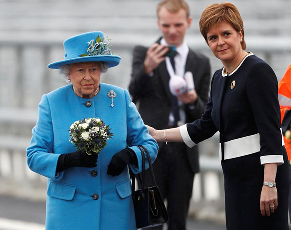 Scotland's First Minister Nicola Sturgeon reaches out to Britain's Queen Elizabeth during the ceremonial opening of the Queensferry Crossing bridge over the Firth of Forth in Scotland, Britain, September 4, 2017. Photo by Russell Cheyne