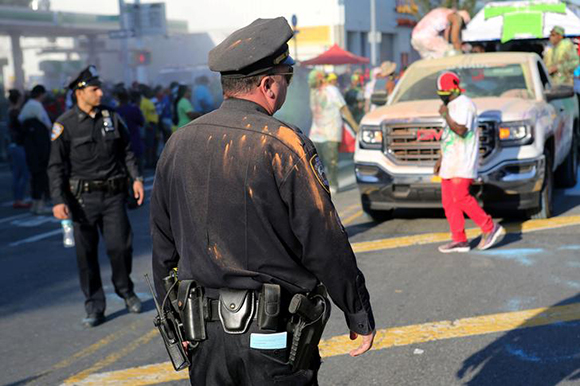 A police officer is covered in paint powder during J'Ouvert, an overnight-into-dawn celebration ahead of the annual West Indian-American Carnival Day Parade in Brooklyn, NY, U.S., September 4, 2017. Photo by Joe Penney