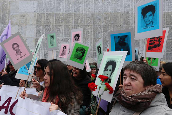 Demonstrators with posters of people who went missing during former General Augusto Pinochet's regime, are seen during a rally marking the anniversary of the 1973 military coup in Santiago, Chile September 10, 2017. REUTERS/Rodrigo Garrido
