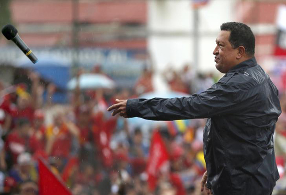 Venezuela's President and presidential candidate Hugo Chavez throws his microphone after speaking during his closing campaign rally in Caracas. Photo by Jorge Silva