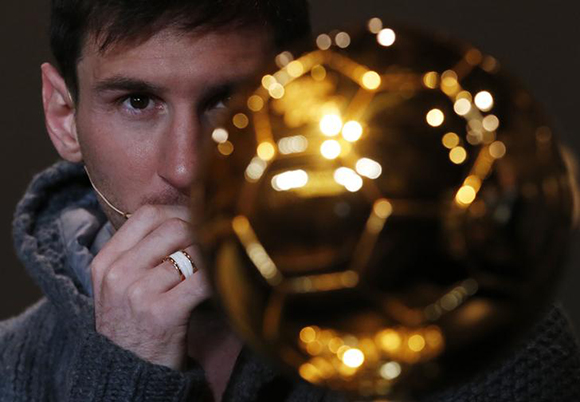 FIFA Men's Ballon d'Or of the Year 2012 nominee Lionel Messi of Argentina looks at the trophy during a news conference before the FIFA Ballon d'Or 2012 soccer awards ceremony at the Kongresshaus. Photo by Michael Buholzer
