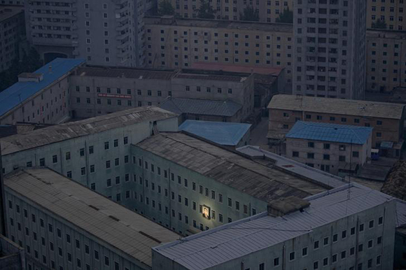  A picture of North Korea's founder Kim Il-sung decorates a building in the capital Pyongyang early. Photo by Damir Sagolj 