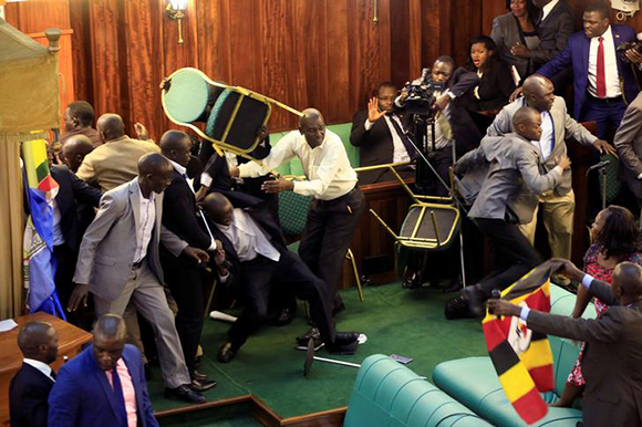  Ugandan opposition lawmakers fight with plain-clothes security personnel in the parliament while protesting a proposed age limit amendment bill debate to change the constitution for the extension of the president's rule, in Kampala, Uganda September 27, 2017. Photo by James Akena 
