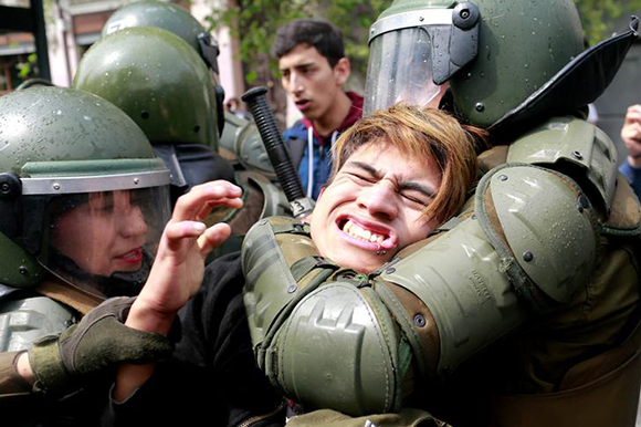  A demonstrator is detained during a rally to request change in the education system in Santiago, Chile September 27, 2017. Photo by Pablo Sanhueza 