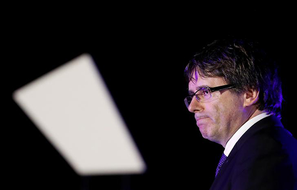 Catalan President Carles Puigdemont leaves the stage after addressing the crowd of people attending a closing rally in favour of the banned October 1 independence referendum in Barcelona, Spain, September 29, 2017. Photo by Yves Herman