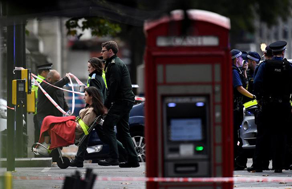 Emergency services personnel wheel a woman in a wheelchair to a nearby ambulance near the Natural History Museum, after a car mounted the pavement, in London, Britain October 7, 2017. Photo by Dylan Martinez 