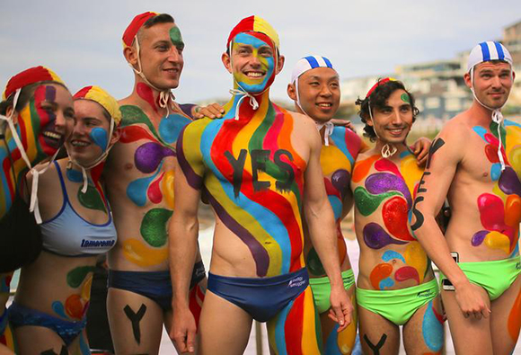 People with their bodies painted participate in an event supporting a 'Yes' vote in a non-binding poll, conducted by post to inform the government on whether voters want Australia to become the 25th nation to permit same-sex marriage, at Sydney's Tamarama Beach in Australia, October 8, 2017. Photo by Steven Saphore