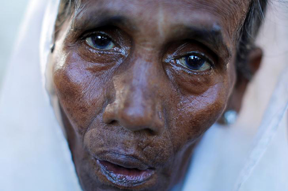A Rohingya refugee woman rests after crossing the Myanmar-Bangladesh border in Palang Khali, Bangladesh October 10, 2017. Photo by Jorge Silva