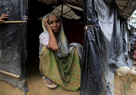  A Rohingya refugee woman sits in her tent in the Kutupalong Refugee Camp in Cox's Bazar, Bangladesh. Photo by Zohra Bensemra 