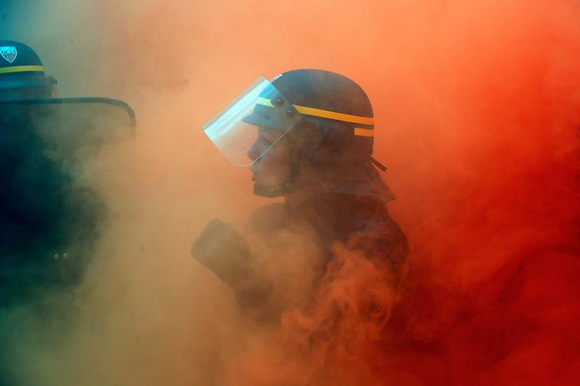  A French CRS riot policewoman faces with French steel workers from the French CGT trade union during a demonstration in Paris, France, October 13, 2017. Photo by Charles Platiau 