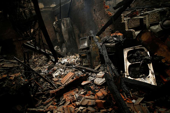  A burnt house is seen following a forest fire in Vila Nova, near Vouzela, Portugal, October 16, 2017. Photo by Pedro Nunes 