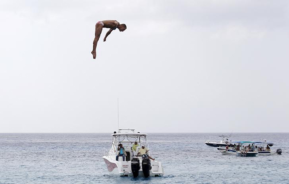 Sasha Kutsenko from Ukraine performs a dive during the FINA High Diving World Cup in Cozumel, Mexico. Photo by Victor Ruiz Garcia