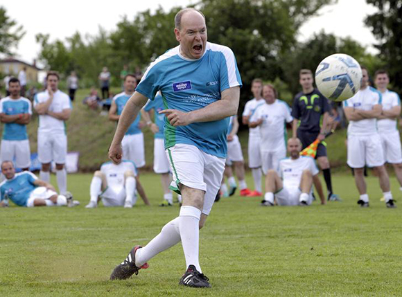 Prince Albert II of Monaco kicks the ball during a charity soccer match in Bilje, Slovenia Photo by Srdjan Zivulovic