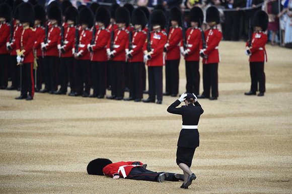  A Guardsman faints at Horseguards Parade for the annual Trooping the Colour ceremony in central London, Britain. Photo by Dylan Martinez 