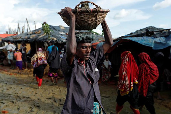  A Rohingya refugee man walks with a basket at Kutupalong refugee camp near Cox's Bazar, Bangladesh Photo by Jorge Silva 