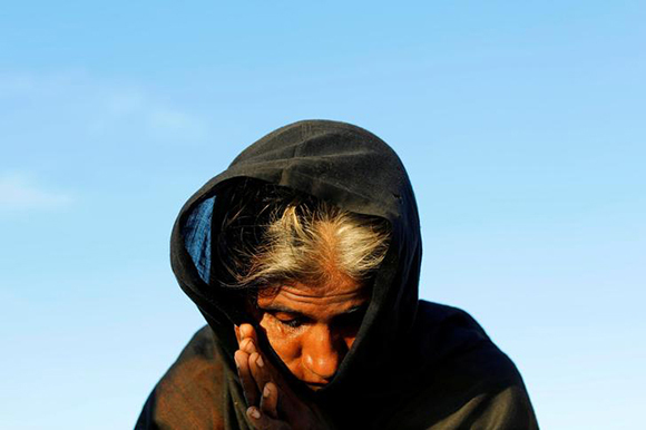  A Rohingya refugee woman waits for permission from the Bangladeshi army to continue, after crossing from Myanmar, in Teknaf, Bangladesh Photo by Jorge Silva 