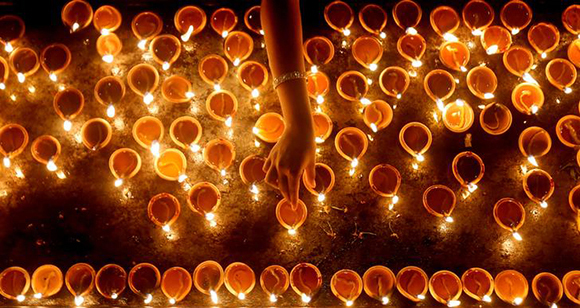  A devotee lights oil lamps at a religious ceremony during the Diwali or Deepavali festival at a Hindu temple in Colombo, Sri Lanka. Photo by Dinuka Liyanawatte 