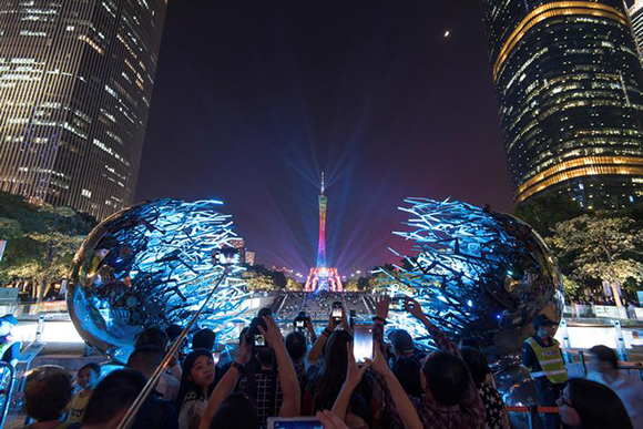  People take pictures of the illuminated Guangzhou TV Tower during a light festival in Guangzhou, Guangdong province, China October 27, 2017. Photo by Stringer 