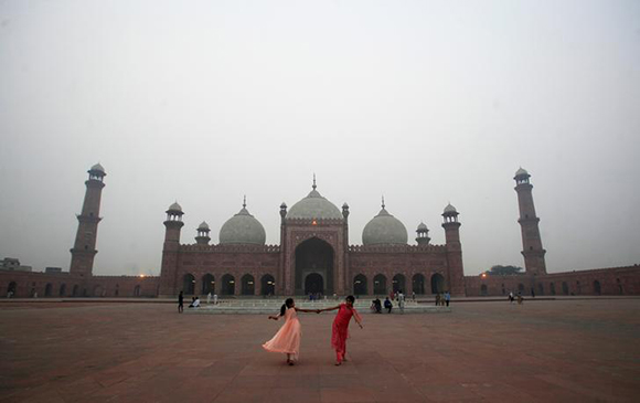  Girls play on the grounds of the Badshahi Mosque during a day with heavy air pollution in Lahore, Pakistan. Photo by Mohsin Raza 