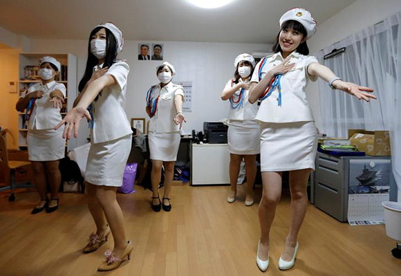  Chunhun (R), the leader of Japan's North Korea fan club called sengun-joshi, or military-first girls, and other members practice a Moranbong Band dance in Tokyo, Japan. Photo by Toru Hanai 