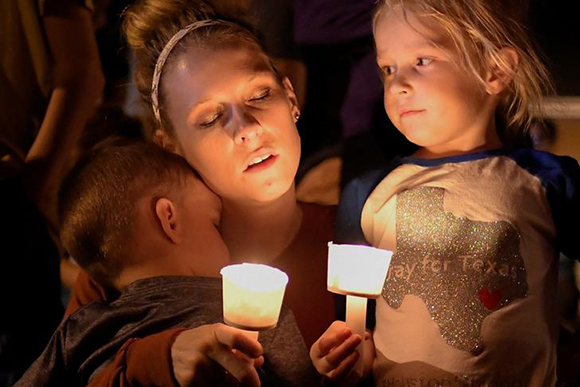  A woman and her children take part in a vigil for victims of a mass shooting in Sutherland Springs, Texas, US., November 5, 2017. Photo by Mohammad Khursheed 