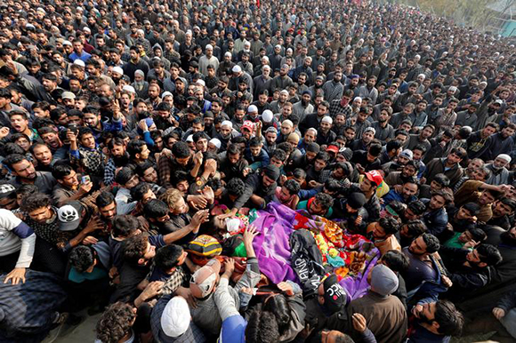  People carry the body of Waseem Ahmad, a suspected militant, who, according to local media, was killed on Monday evening in a gun battle with Indian security forces, during his funeral in Drubgam Village, in Kashmir's Pulwama District November 7, 2017. Photo by Danish Ismail 