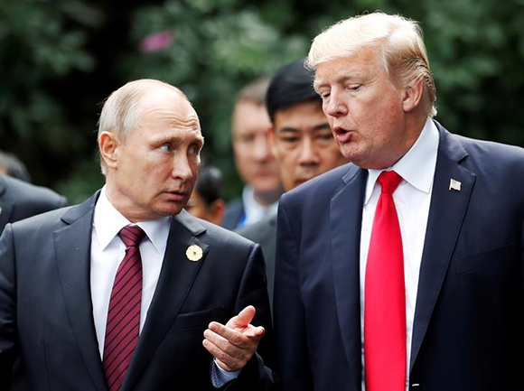 U.S. President Donald Trump and Russia's President Vladimir Putin talk during the family photo session at the APEC Summit in Danang, Vietnam November 11, 2017. Photo by Jorge Silva