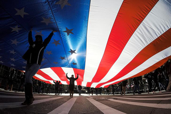 People carry the U.S. flag during the Veterans Day Parade in New York, U.S., November 11, 2017. Photo by Eduardo Munoz