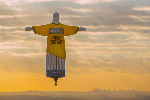  A balloon shaped in the famous 'Christ the Redeemer' statue that overlooks the Brazilian city of Rio de Janeiro floats at sunrise as part of an advertisement campaign for an online betting company above the Australian city of Sydney. Photo by Steve Christo 