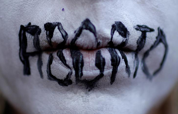  A woman demonstrates against Brazil's congressional move to criminalize all cases of abortion, including cases of rape and where the mother's life is in danger, with a face painting representing a woman dead after an illegal abortion, in Rio de Janeiro, Brazil. Photo by Ricardo Moraes 