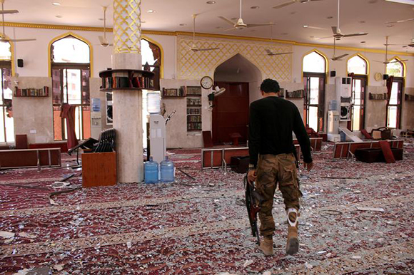 A member of security forces organized by the Saudi-led coalition inspects a mosque damaged in a suicide car bomb attack outside a police forces camp in Aden, Yemen, November 14, 2017. Photo by Fawaz Salman