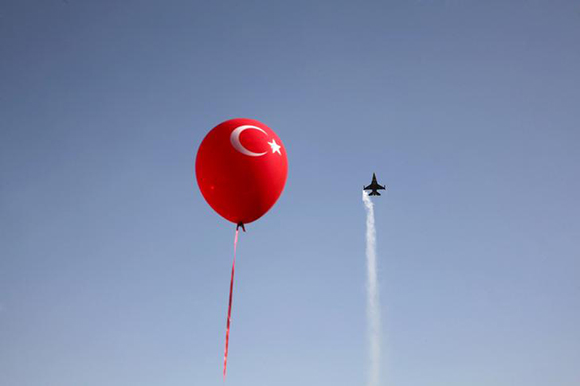 A Turkish military airplane flies over a military parade marking the 34th anniversary of the Declaration of Independence of the Turkish Republic of Northern Cyprus, a breakaway state recognized only by Turkey, in northern Nicosia, Cyprus November 15, 2017. Photo byYiannis Kourtoglou