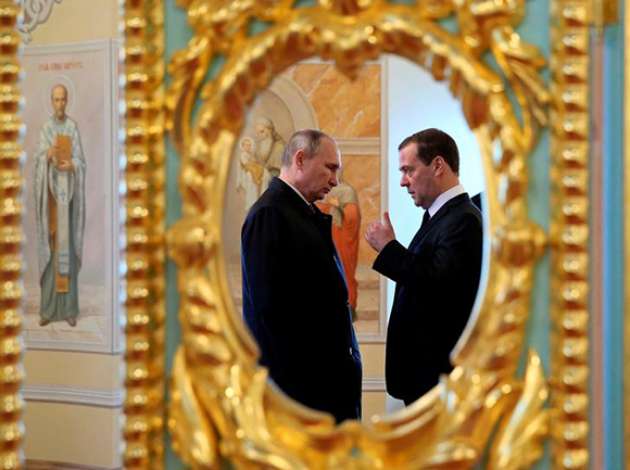 Russia's President Vladimir Putin and Prime Minister Dmitry Medvedev are reflected in a mirror while visiting the Resurrection New Jerusalem Monastery at Istra, outside Moscow, Russia November 15, 2017. Photo by Ekaterina Shtukina