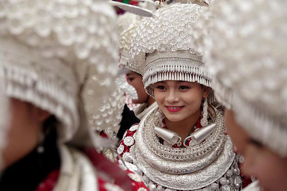 Ethnic Miao women wearing traditional costumes take part in a parade during the traditional Lusheng (reed-pipe wind instrument) festival in Gulong, Guizhou province, China November 15, 2017. Picture taken November 15, 2017. Photo by Stringer