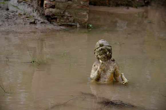  An ancient statue is partly submerged under water at an archaeological site, following flash floods which hit the area, at the village of Dion, Greece. Photo by Alexandros Avramidis 