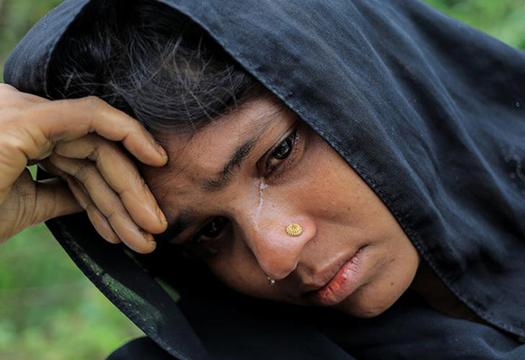  A Rohingya refugee woman who crossed the border from Myanmar this week cries while waiting to get a shelter in Kotupalang refugee camp near Cox's Bazar, Bangladesh. Photo by Zohra Bensemra 