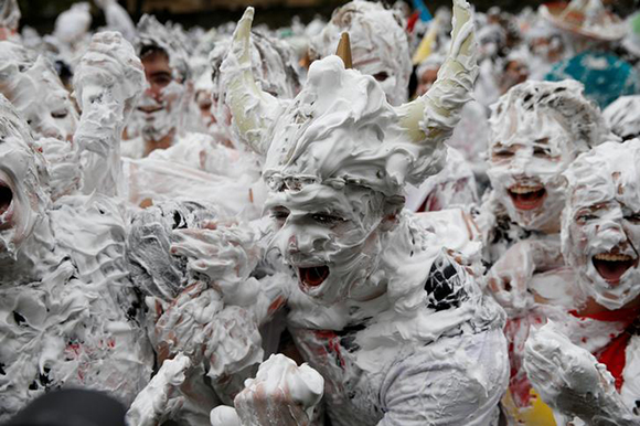  Students from St Andrews University are covered in foam as they take part in the traditional 'Raisin Weekend' in the Lower College Lawn, at St Andrews in Scotland, Britain. Photo by Russell Cheyne 