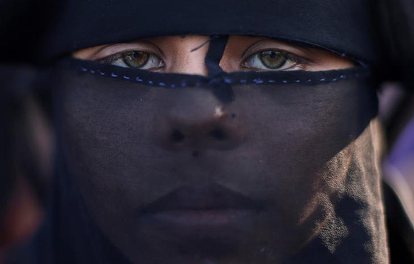  Sanuara Begum, 13, a Rohingya refugee, waits to receive permission from the Bangladeshi army to continue her way after crossing the Bangladesh-Myanmar border, at a port in Teknaf, Bangladesh. Photo by Adnan Abidi 