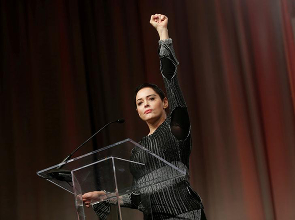  Actor Rose McGowan raises her fist after addressing the audience during the opening session of the three-day Women's Convention at Cobo Center in Detroit, Michigan, U.S., October 27, 2017. Photo by Rebecca Cook 