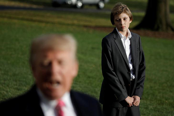  U.S. President Donald Trump talks with the reporters as his son Barron waits for him while departing the White House for Palm Beach, in Washington D.C., U.S. November 21, 2017. Photo by Carlos Barria 