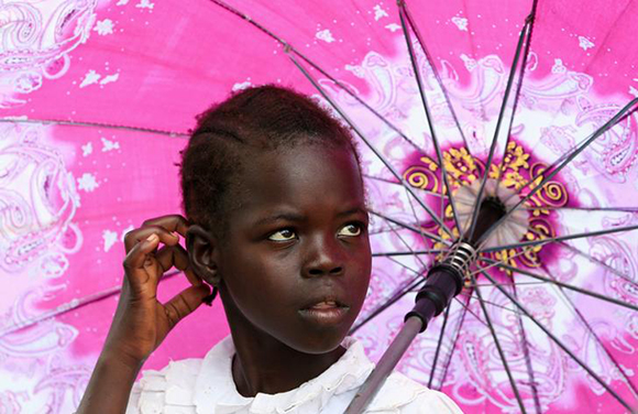  A refugee girl from South Sudan waits to receive food from the World Food Program (WFP) in Palorinya settlement in Moyo district northern Uganda. Photo by James Akena 