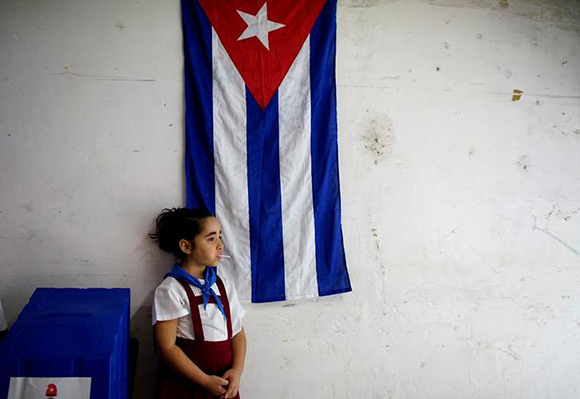  Sofia Ema, 8, waits for voters at a polling station in Havana, Cuba, November 26, 2017. Photo by Alexandre Meneghini 