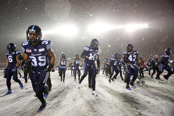 The Toronto Argonauts run on the field before the start of the Canadian Football League's (CFL) 105th Grey Cup championship game against the Calgary Stampeders in Ottawa, Ontario, Canada. Photo by Chris Wattie 